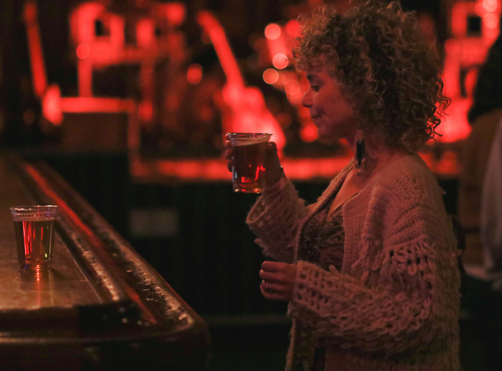 Alicia LaVaute grabs a drink from the bar
